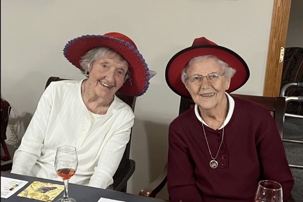 Two women wearing hats